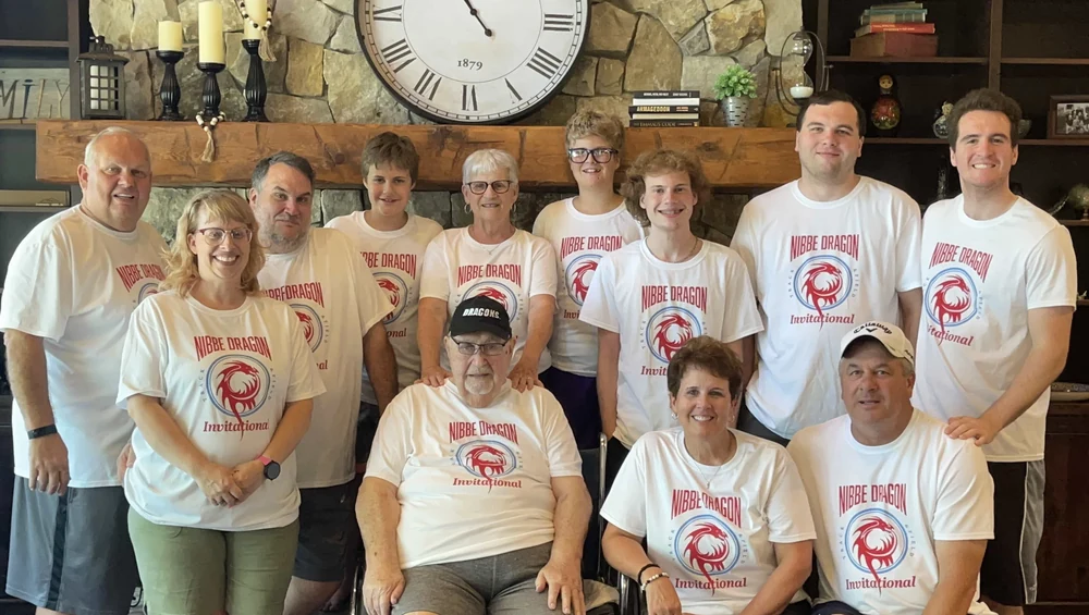 The Nibbe family gathered together wearing matching Nibbe Dragons Invitational shirts.